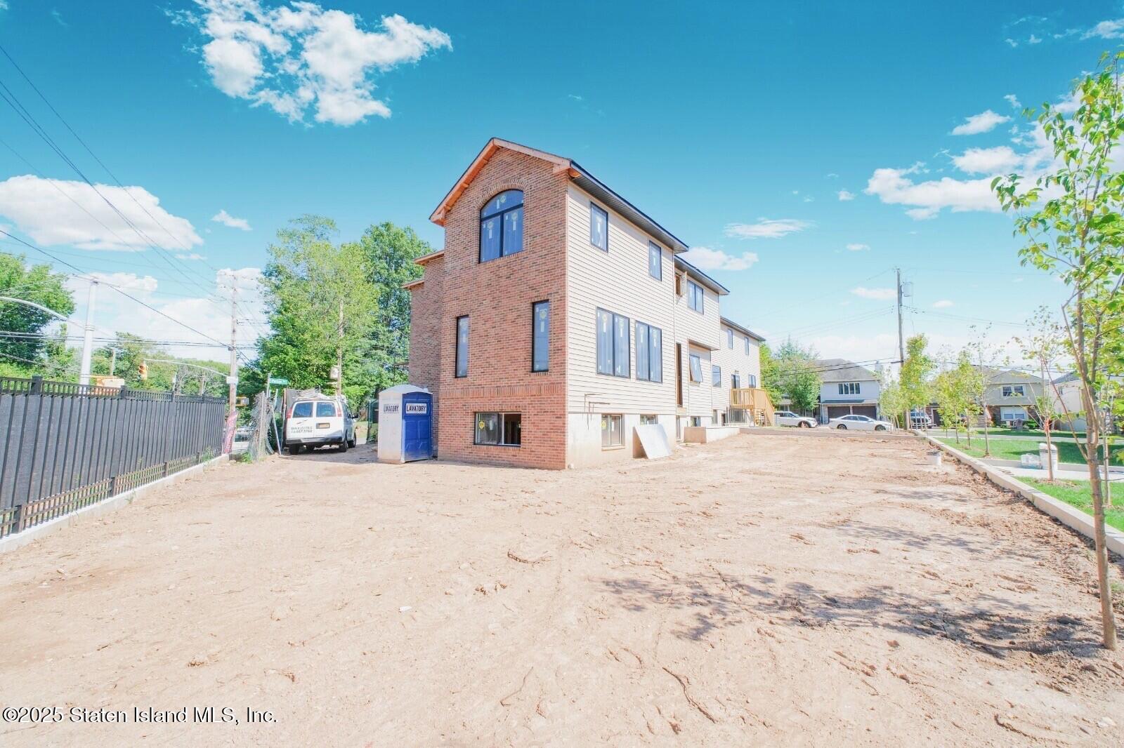 344 Poillon Avenue Staten Island, NY 10312 - Photo 2 of 3 a front view of a house with a yard and garage
