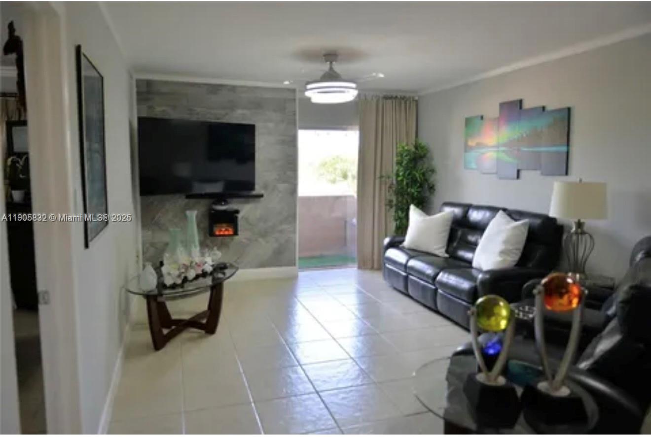 10900 Southwest 104th Street, Unit 314 Miami, FL 33176 - Photo 3 of 13 a living room with furniture and a flat screen tv