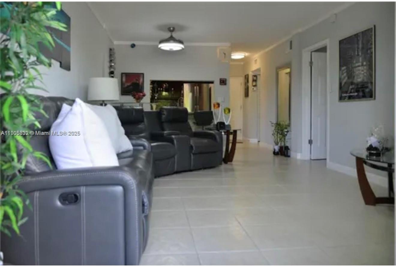 10900 Southwest 104th Street, Unit 314 Miami, FL 33176 - Photo 4 of 13 a living room with furniture and a flat screen tv