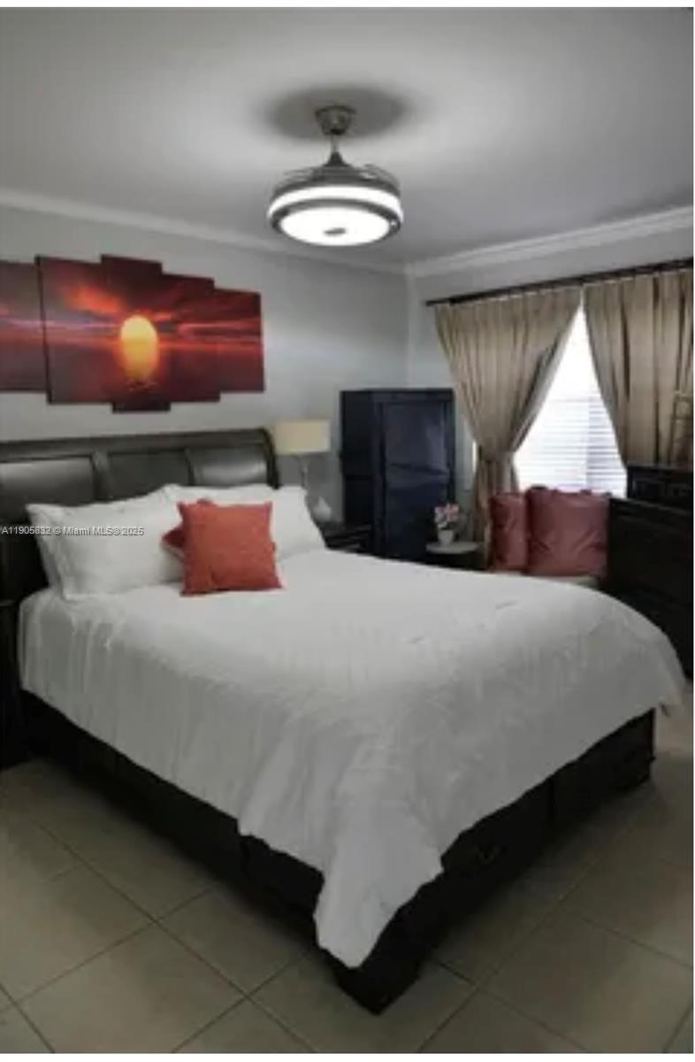 10900 Southwest 104th Street, Unit 314 Miami, FL 33176 - Photo 7 of 13 a bedroom with a bed and a flat screen tv