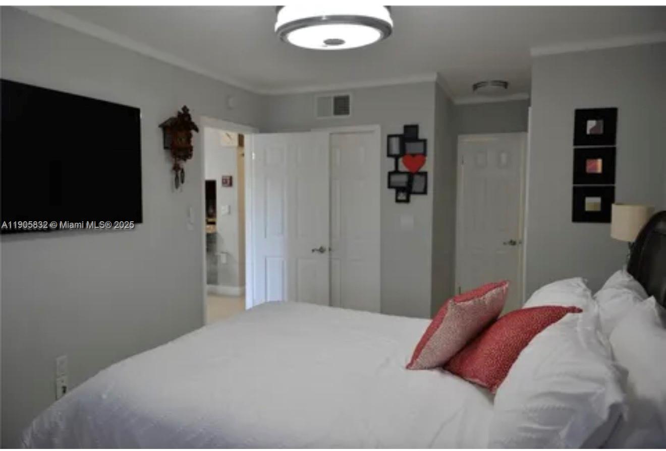 10900 Southwest 104th Street, Unit 314 Miami, FL 33176 - Photo 8 of 13 a bedroom with a bed and a flat screen tv