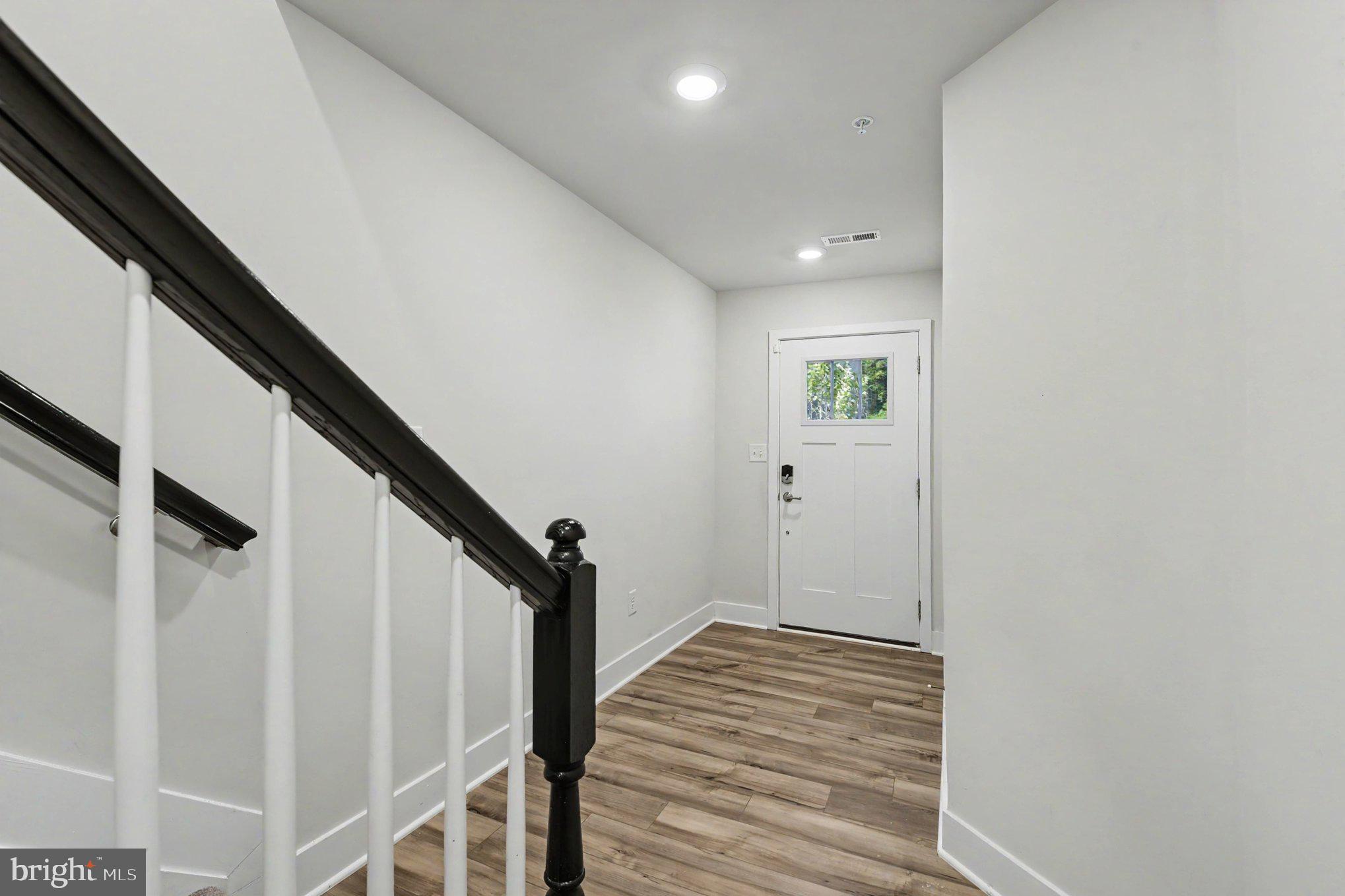 238 Waterstone Road Essex, MD 21221 - Photo 6 of 39 a view of a hallway with wooden floor and staircase