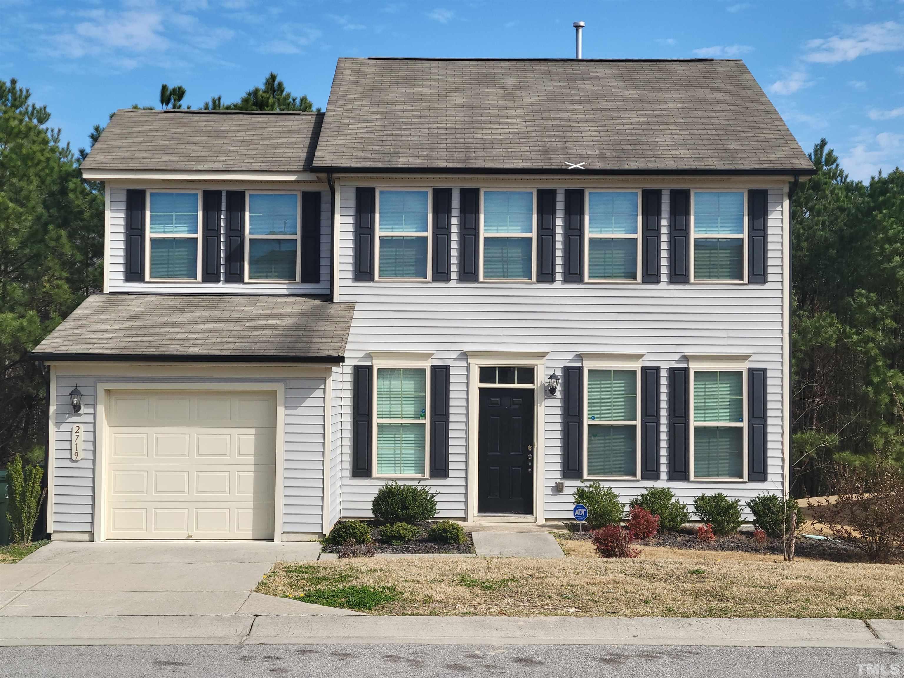 2719 Follow Me Way Raleigh, NC 27610 - Photo 1 of 25 a front view of a house with a garden and plants