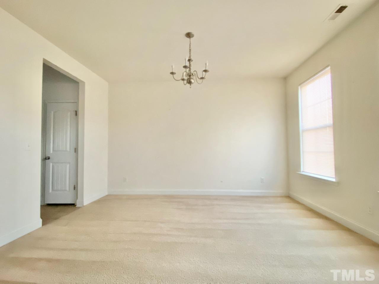 2719 Follow Me Way Raleigh, NC 27610 - Photo 4 of 25 wooden floor in an empty room with a window