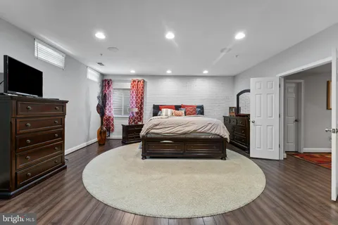 a spacious bedroom with a bed and a flat screen tv
