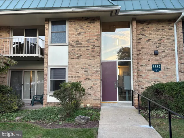 a front view of a house with plants