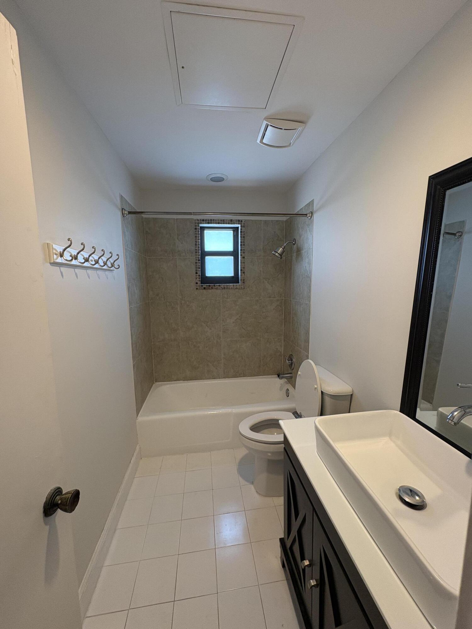 360 Wilma Circle, Unit 5 Riviera Beach, FL 33404 - Photo 16 of 16 a bathroom with a sink a toilet and shower