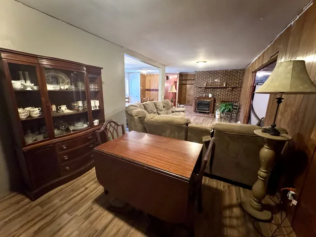 a living room with furniture a lamp and a window