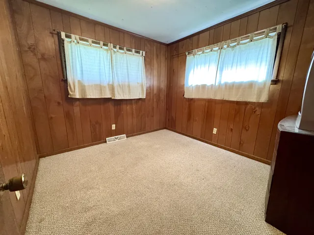 a bedroom with a bed and a mirror