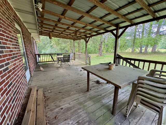 a view of a patio with a table chairs and a backyard