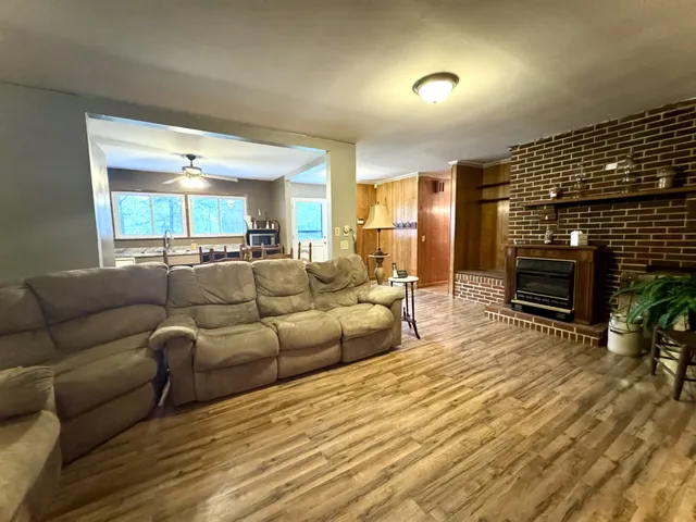 a living room with furniture a fireplace and a flat screen tv