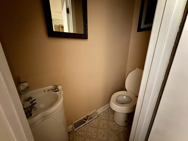 a bathroom with a toilet and a sink