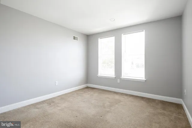 a view of a hallway with wooden floor and entryway