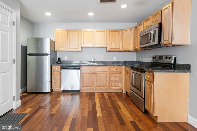 a view of room with window and wooden floor