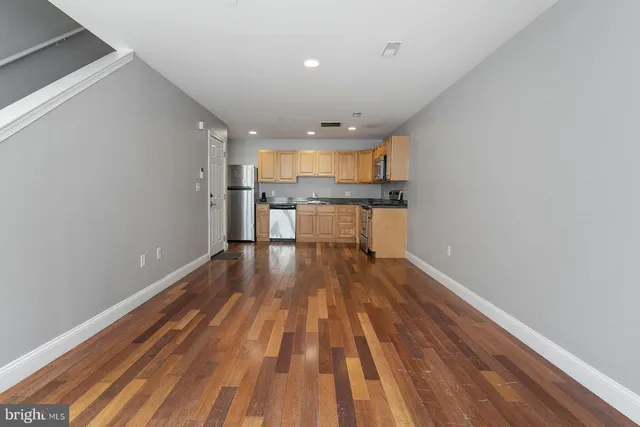 a bathroom with a shower sink vanity and mirror