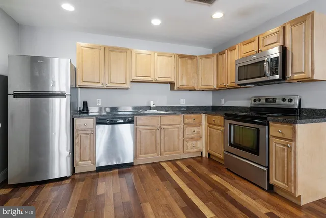 a view of a hallway with a wooden door