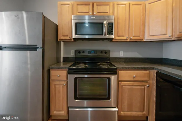 a kitchen with a refrigerator sink and microwave