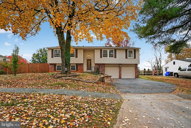 a view of a house with a yard covered in snow