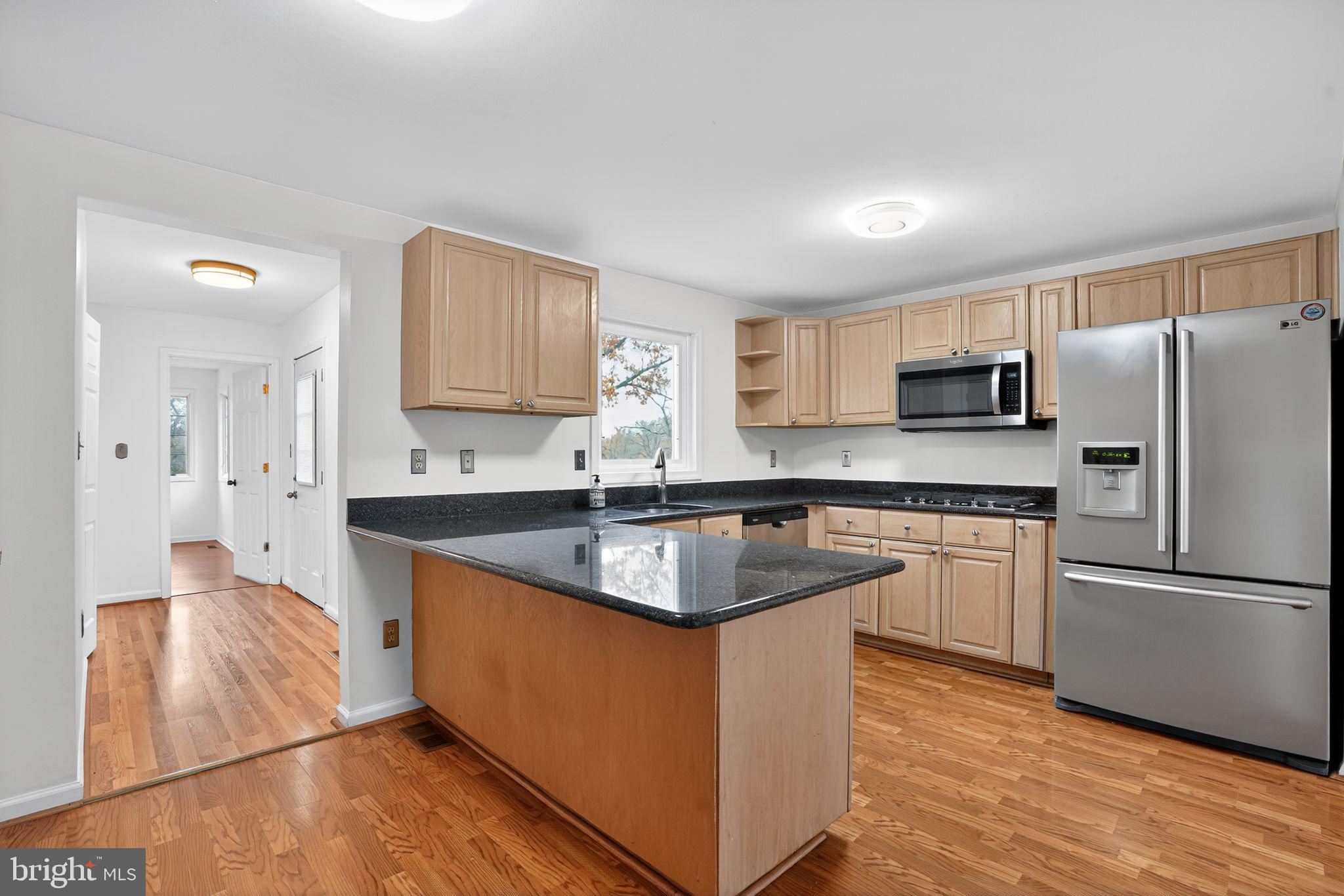 1513 Rainbow Drive Silver Spring, MD 20905 - Photo 11 of 58 a kitchen with stainless steel appliances granite countertop a sink stove and refrigerator