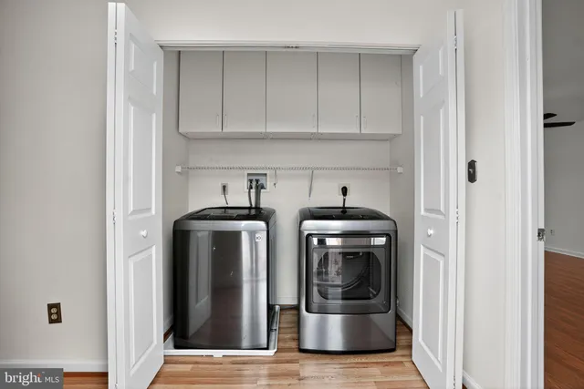 a view of kitchen with refrigerator and cabinets