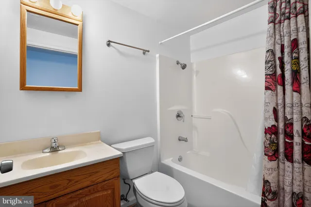 a bathroom with a sink toilet vanity granite tub and shower