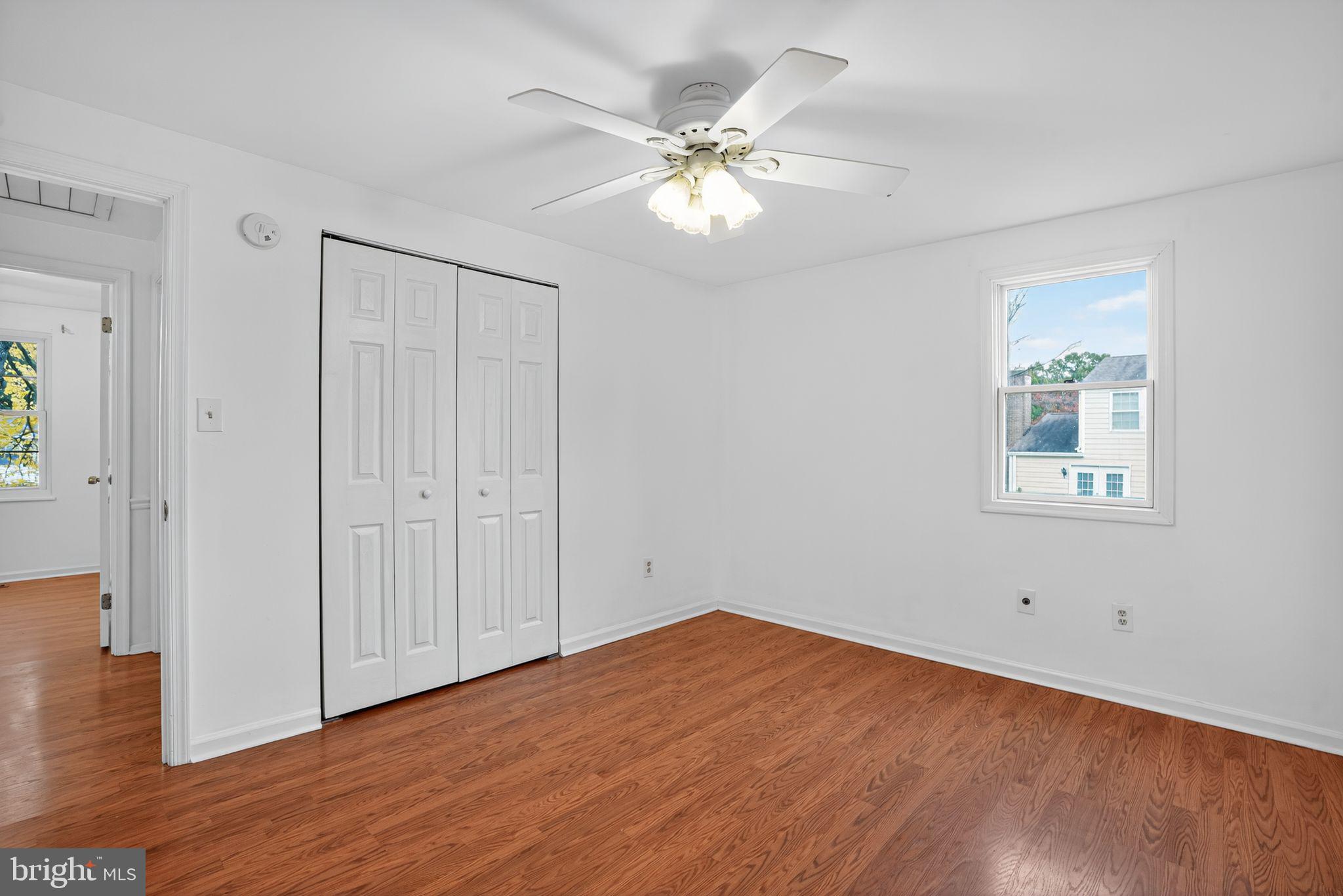 1513 Rainbow Drive Silver Spring, MD 20905 - Photo 27 of 58 a view of a room with wooden floor and a ceiling fan