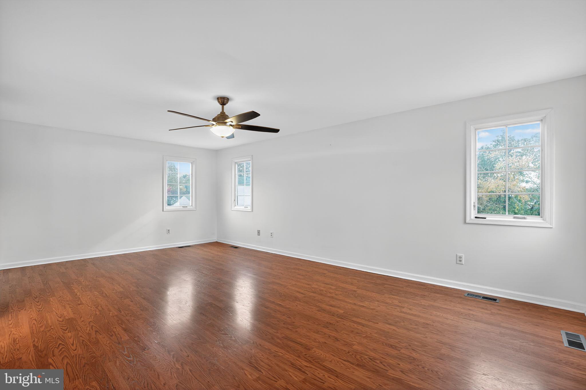 1513 Rainbow Drive Silver Spring, MD 20905 - Photo 30 of 58 wooden floor in an empty room with a window