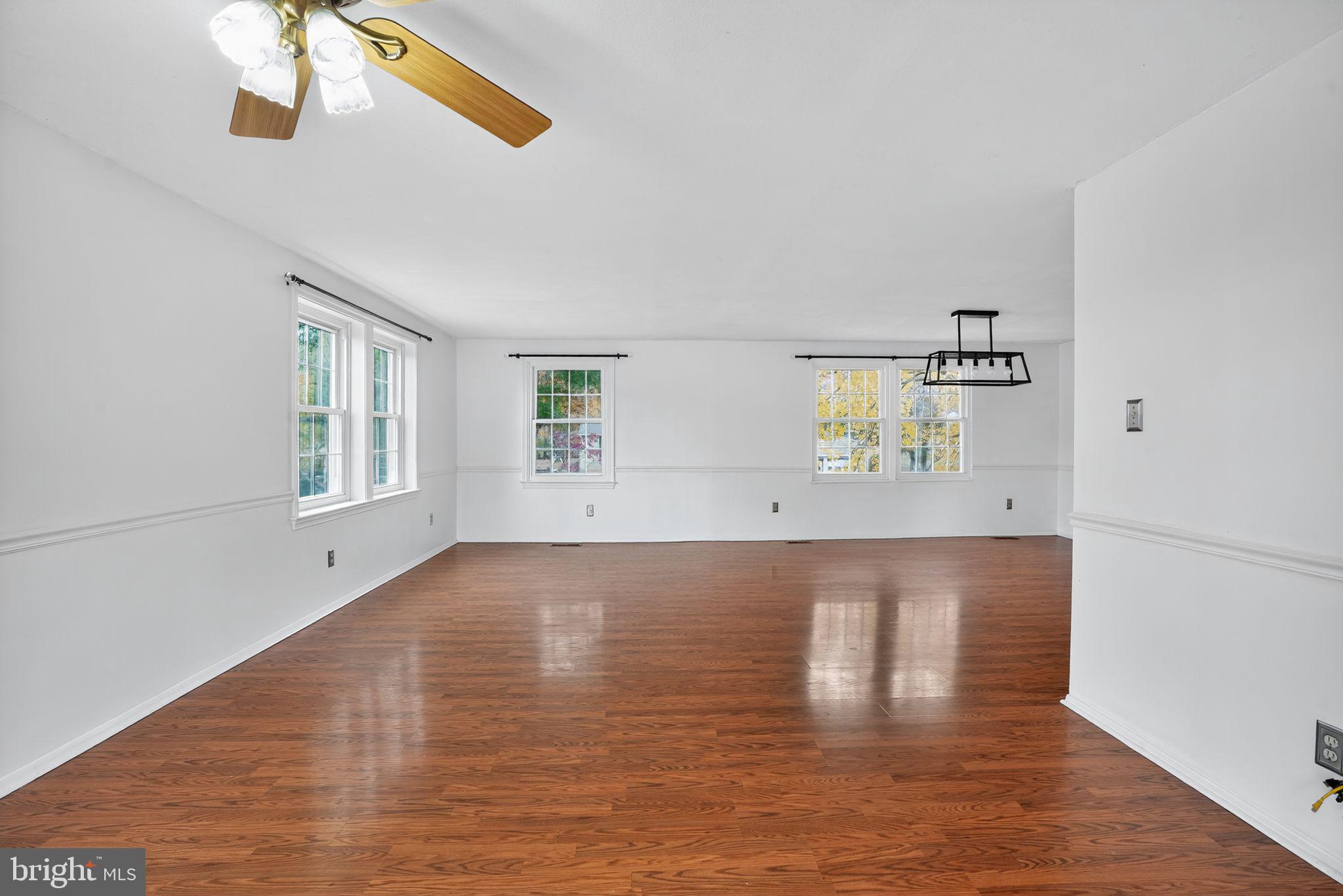 1513 Rainbow Drive Silver Spring, MD 20905 - Photo 3 of 58 a view of an empty room with wooden floor and a window