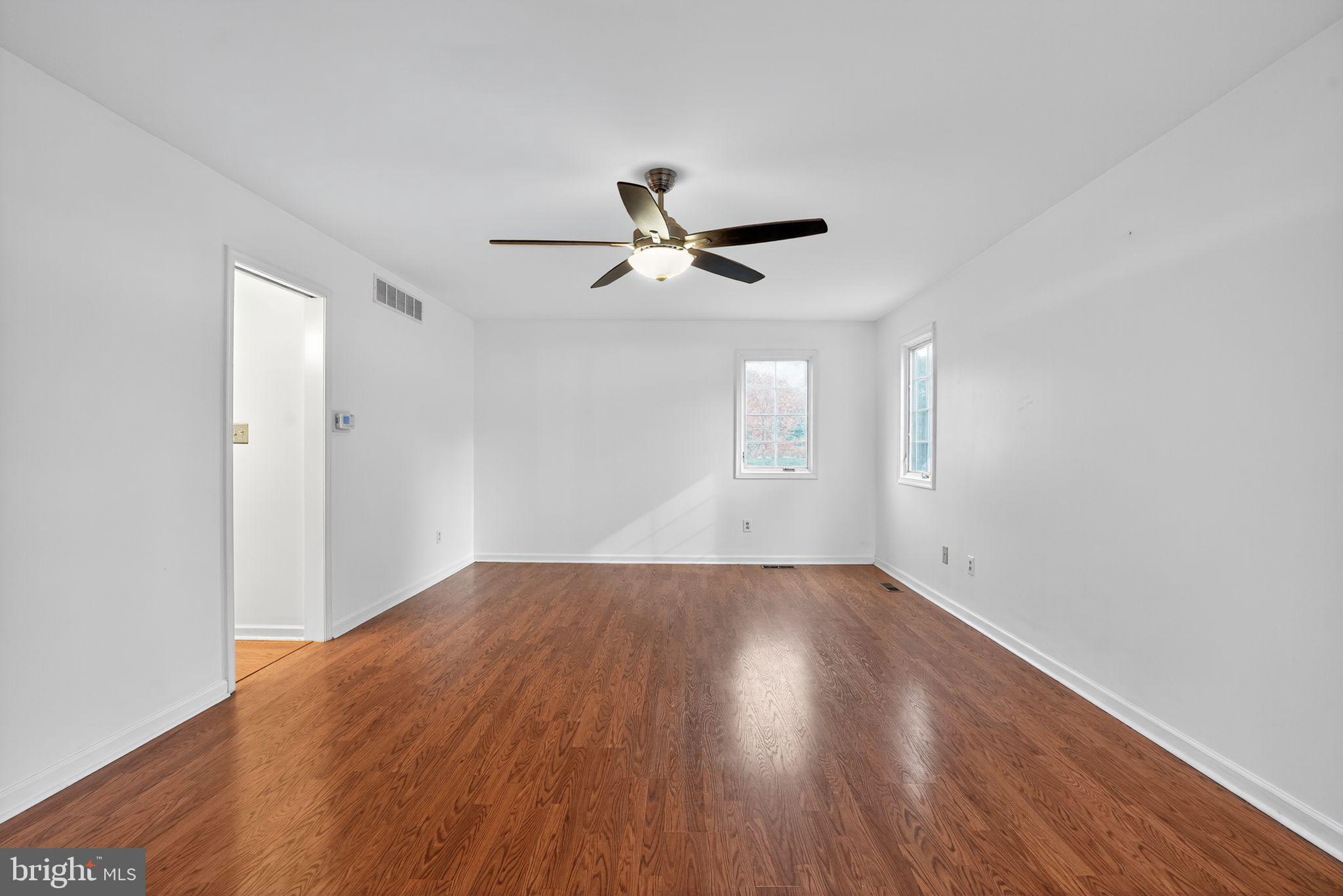 1513 Rainbow Drive Silver Spring, MD 20905 - Photo 34 of 58 wooden floor in an empty room with a window
