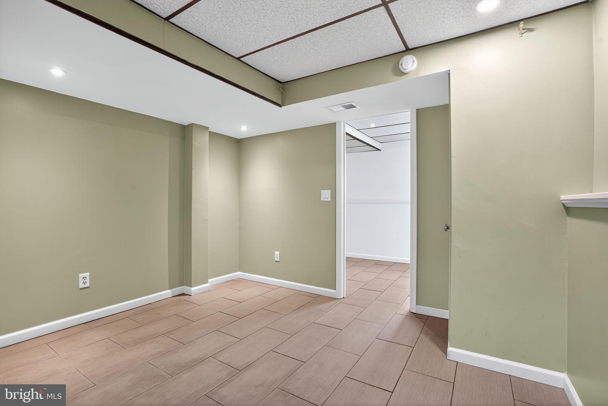 1513 Rainbow Drive Silver Spring, MD 20905 - Photo 41 of 58 a view of a hallway with wooden floor