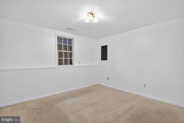 a view of a yard with wooden fence