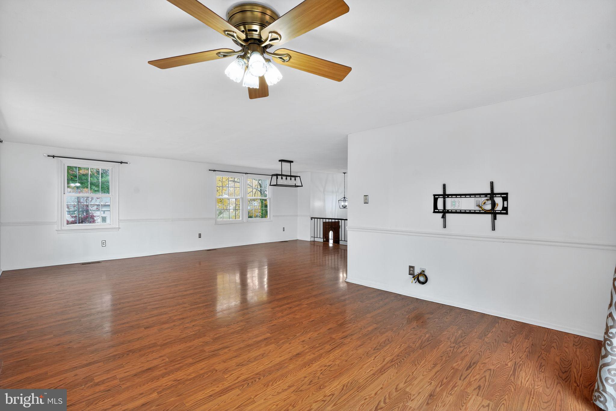 1513 Rainbow Drive Silver Spring, MD 20905 - Photo 10 of 58 wooden floor with white walls and chandelier fan