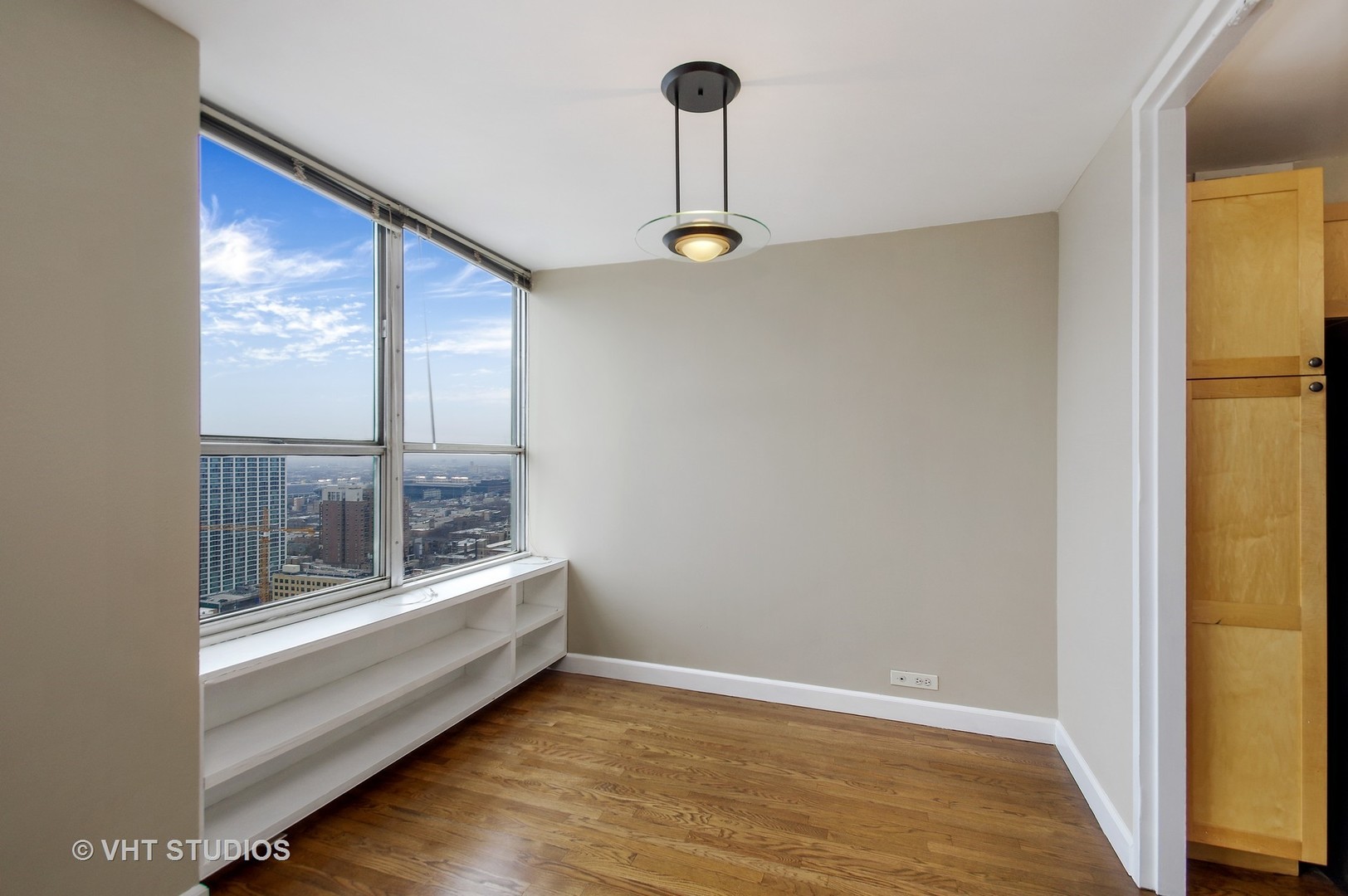655 West Irving Park Road, Unit 2713 Chicago, IL 60613 - Photo 12 of 26 a view of room with window and wooden floor