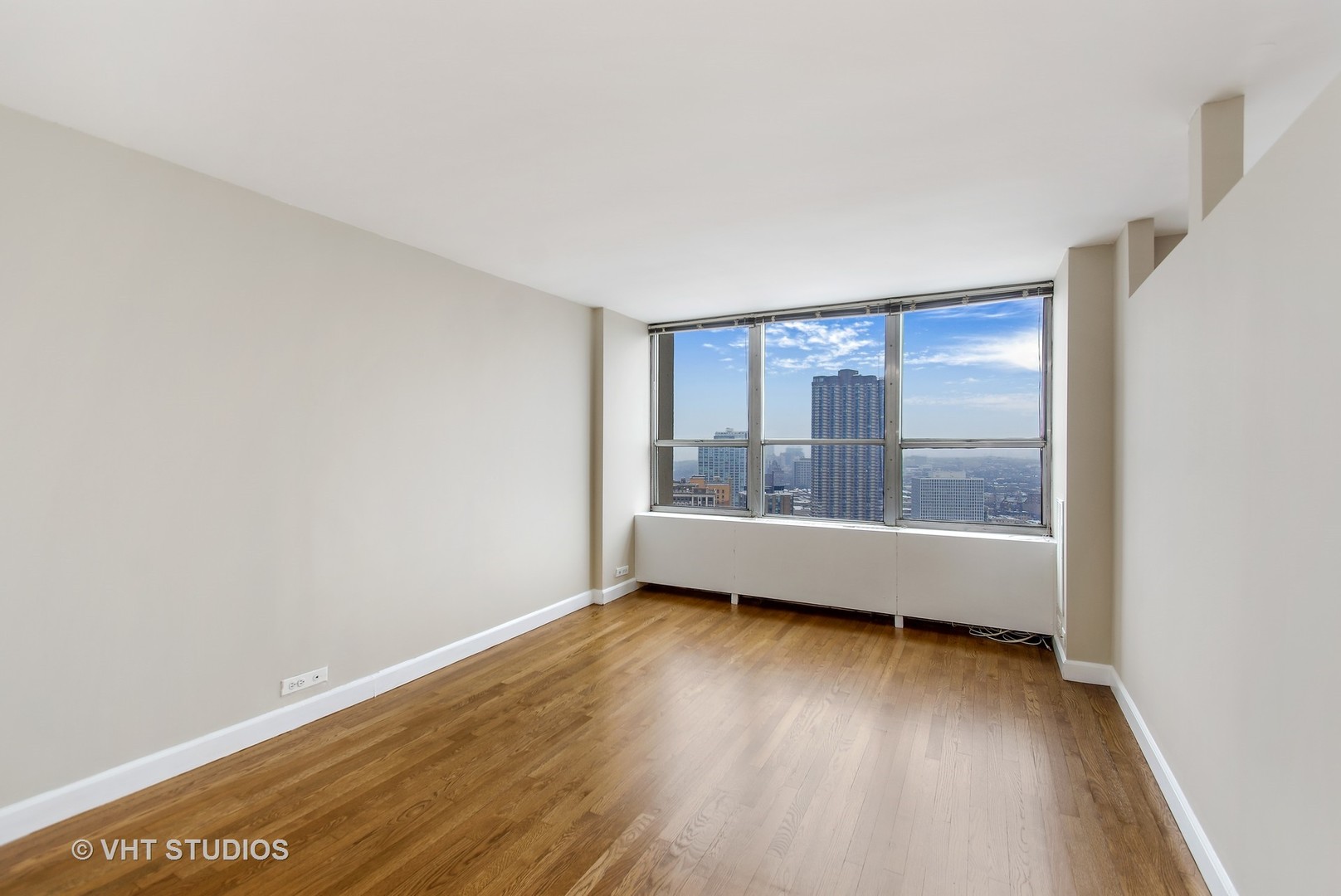 655 West Irving Park Road, Unit 2713 Chicago, IL 60613 - Photo 16 of 26 a view of room with hardwood floor and window