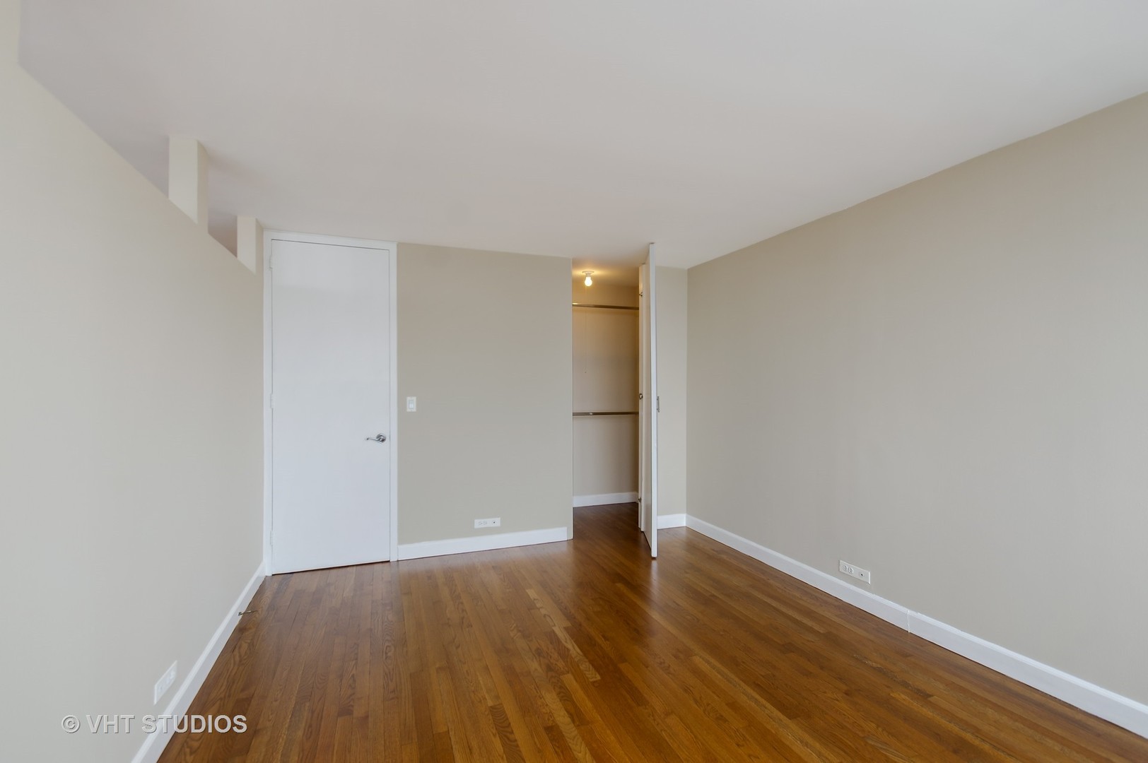655 West Irving Park Road, Unit 2713 Chicago, IL 60613 - Photo 17 of 26 a view of an empty room with wooden floor