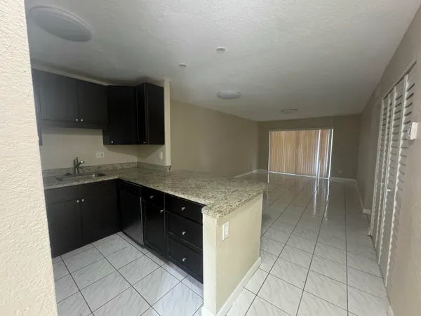 a kitchen with a stove top oven and cabinets