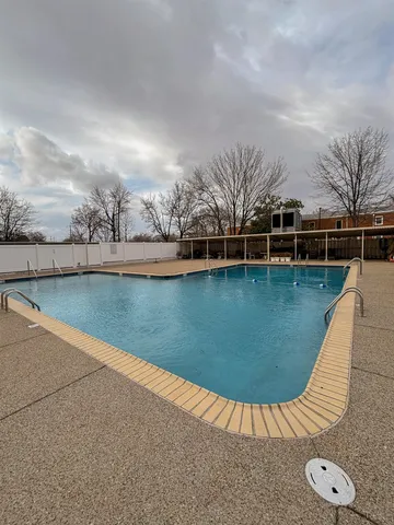 a view of a swimming pool with lounge chair