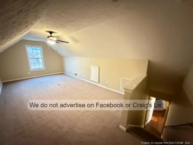 a front view of a house with a yard and tree