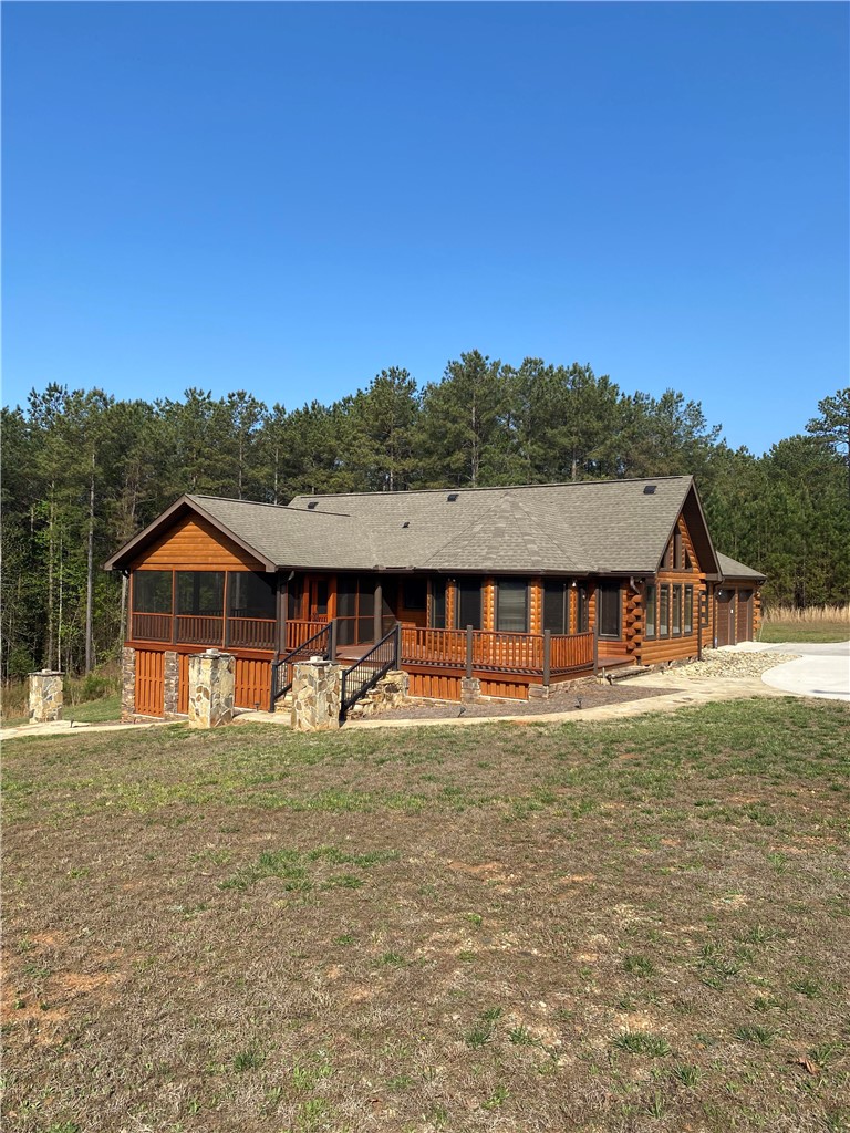 128 McAlister Road West Union, SC 29696 - Photo 2 of 40 A charming log home with a screened porch and expansive decking offers idyllic country living.