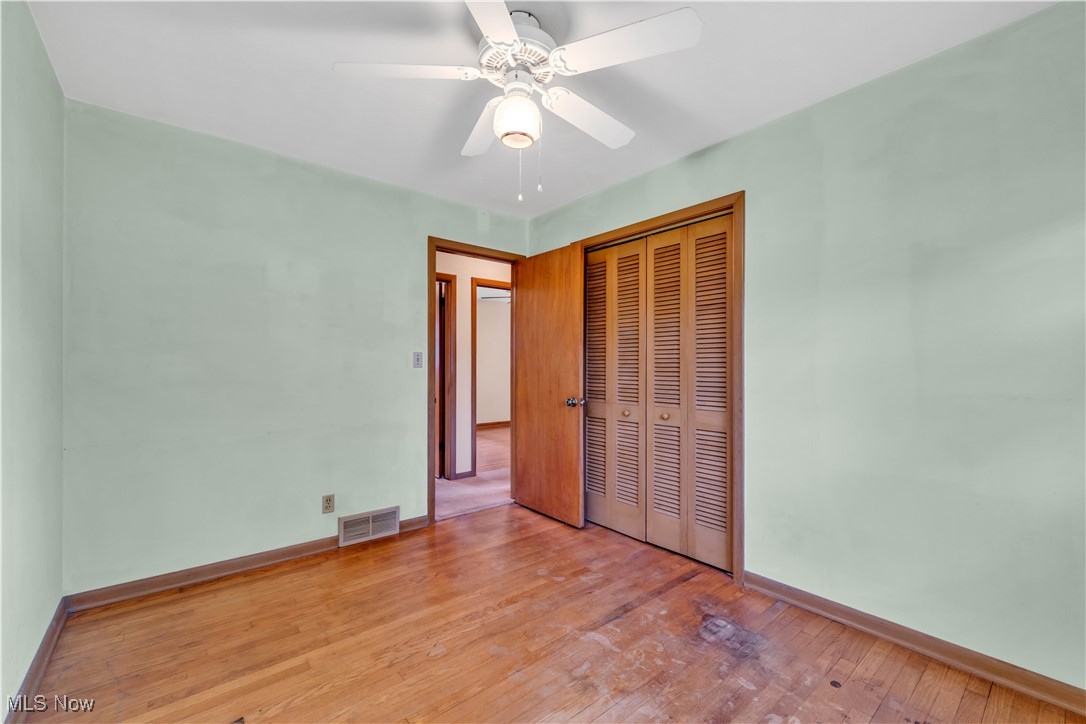 38450 Otten Road North Ridgeville, OH 44039 - Photo 29 of 45 Unfurnished bedroom featuring wood-type flooring, a closet, and a ceiling fan