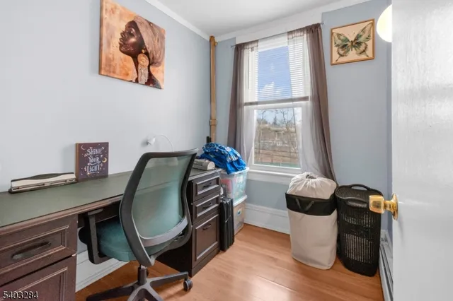 a view of a workspace with furniture and a window
