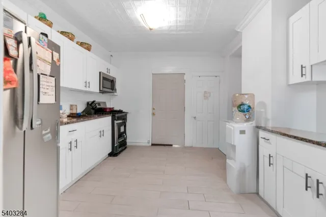 a kitchen with a refrigerator a stove top oven a sink and dishwasher
