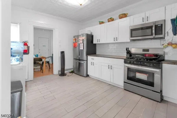 a kitchen with stainless steel appliances a stove a microwave and a refrigerator