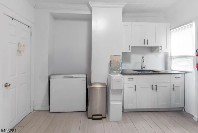 a kitchen with a white stove top oven and white cabinets