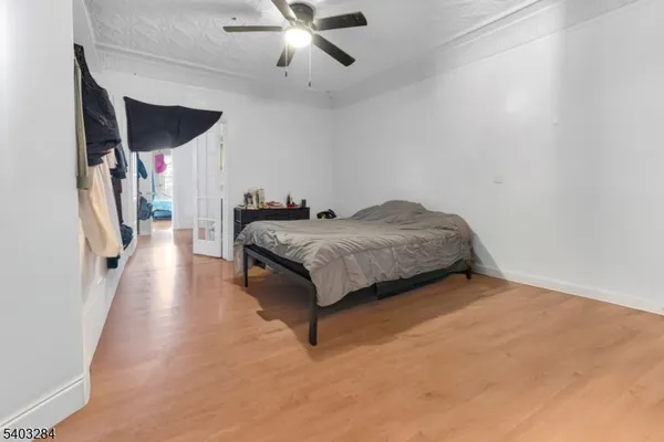 a spacious bedroom with a bed and a chandelier