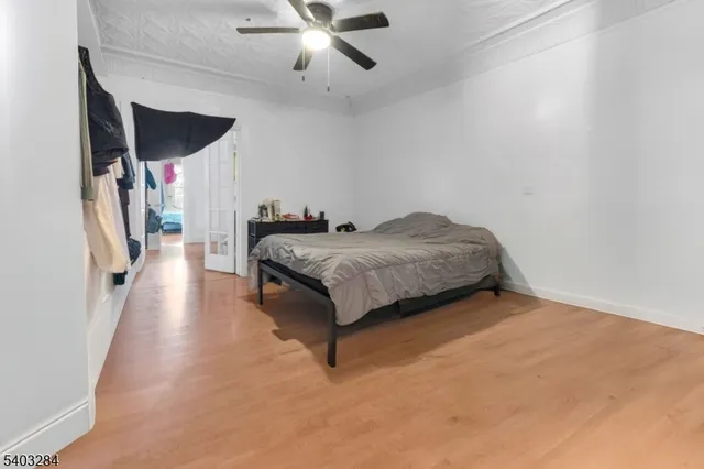 a spacious bedroom with a bed and a chandelier