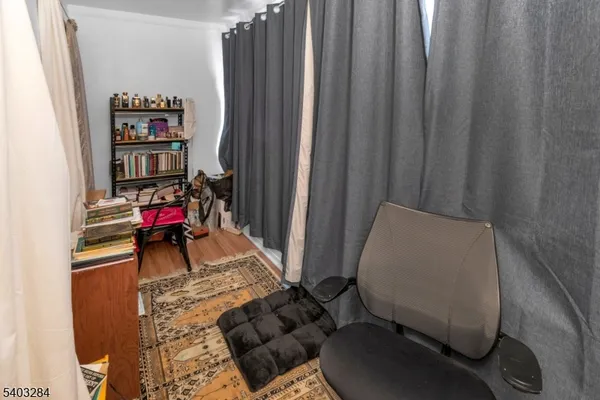 a living room with furniture and a book shelf