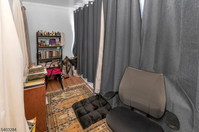 a living room with furniture and a book shelf