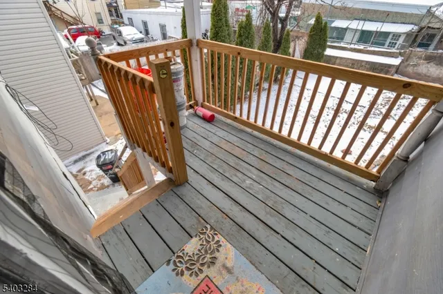 a view of balcony with wooden floor and stairs