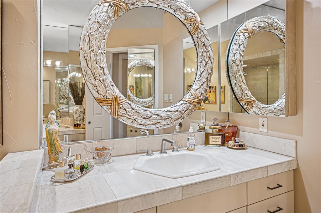 5200 Keller Springs Road, Unit 632 Dallas, TX 75248 - Photo 21 of 36 a bathroom with a mirror and a sink